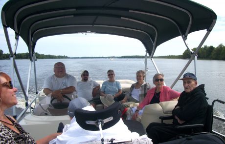 Eight people sitting on pontoon boat