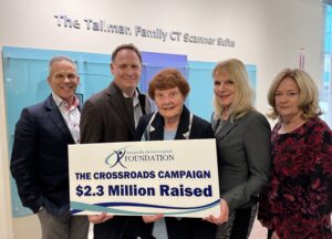 A group of representatives from Kemptville District Hospital, the hospital's Foundation, and both organizations boards, stand together to announce the total raised through the Crossroads Campaign to bring a CT Scanner to Kemptville.